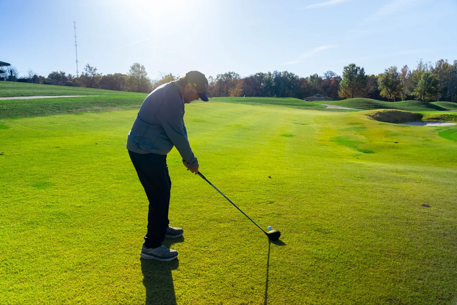 A golfer at address on the tee
